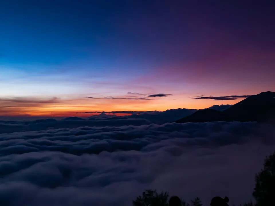 Sea of clouds below the Bali highlands at sunrise