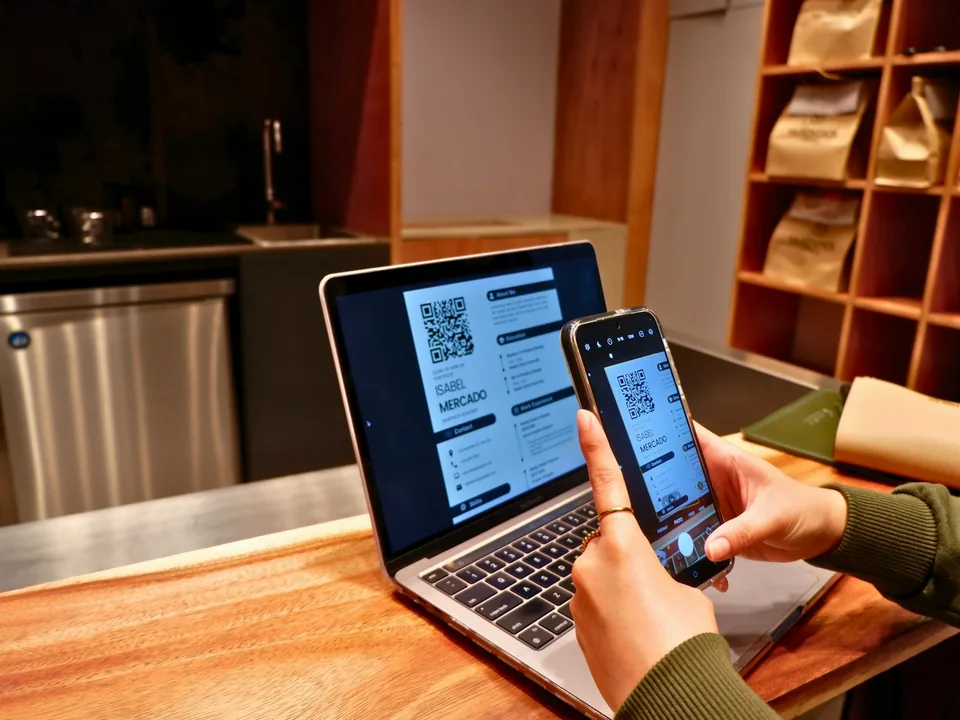 Completing an online visa application on a laptop and phone