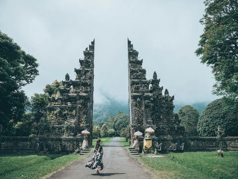 Traveller walking through the Handara Gate in the Bali highlands