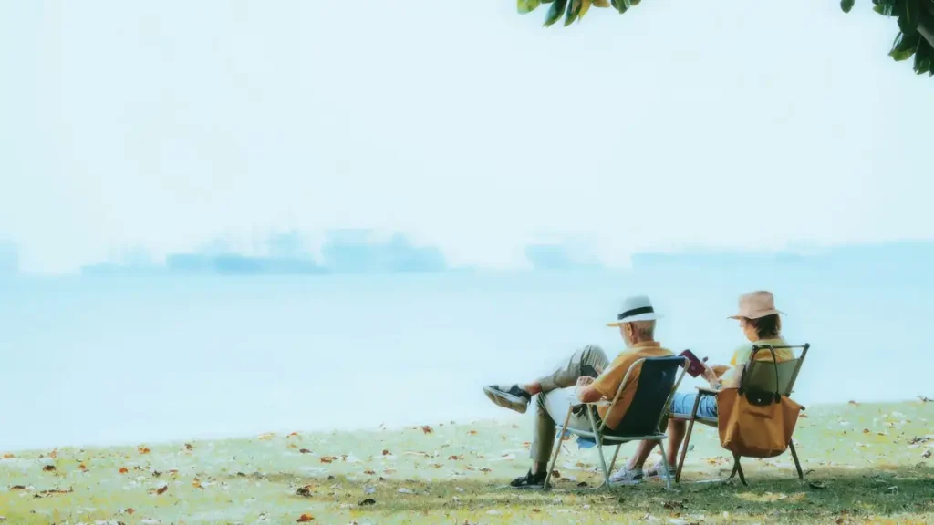 An elderly couple relaxing by the ocean, reflecting British retirees settling in Bali