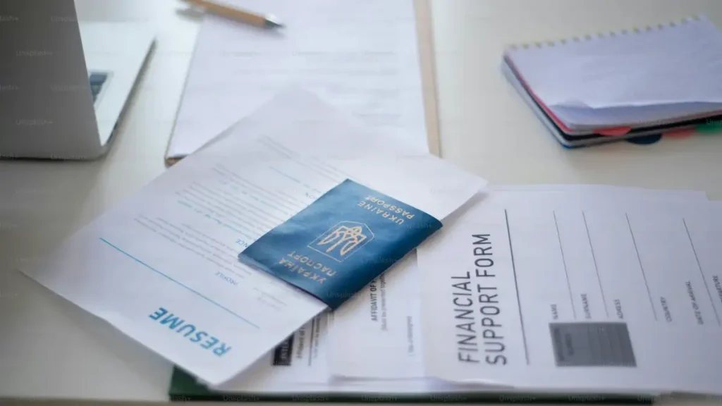 Visa application forms spread across a desk, where common application mistakes happen