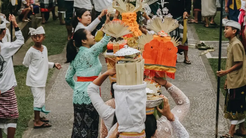 A Balinese ceremonial procession on the street during a traditional festival