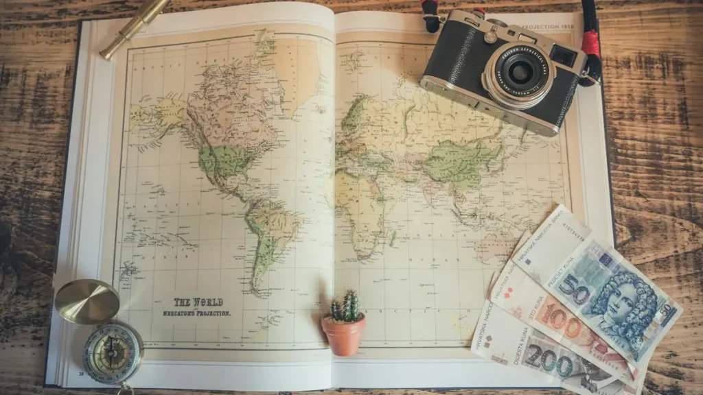 A camera, passport, map and banknotes laid out for a 2027 trip to Bali