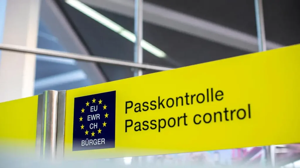 Passport control signage at an international airport immigration hall