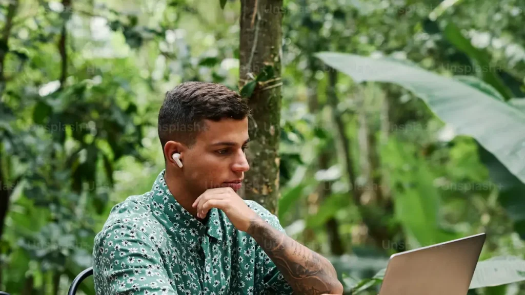 A man applying online at a laptop, reflecting digital Bali visa services for UK applicants